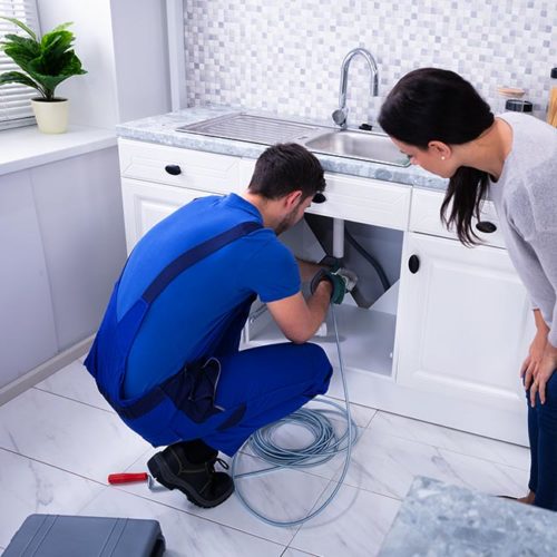 plumber-unclogging-a-clogged-drain-maplewood-mn